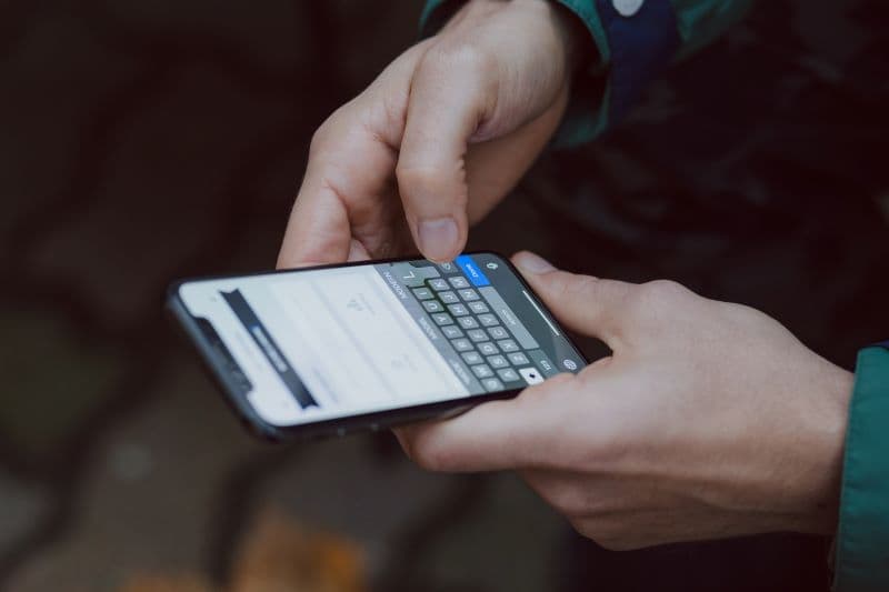 man holding a smartphone min