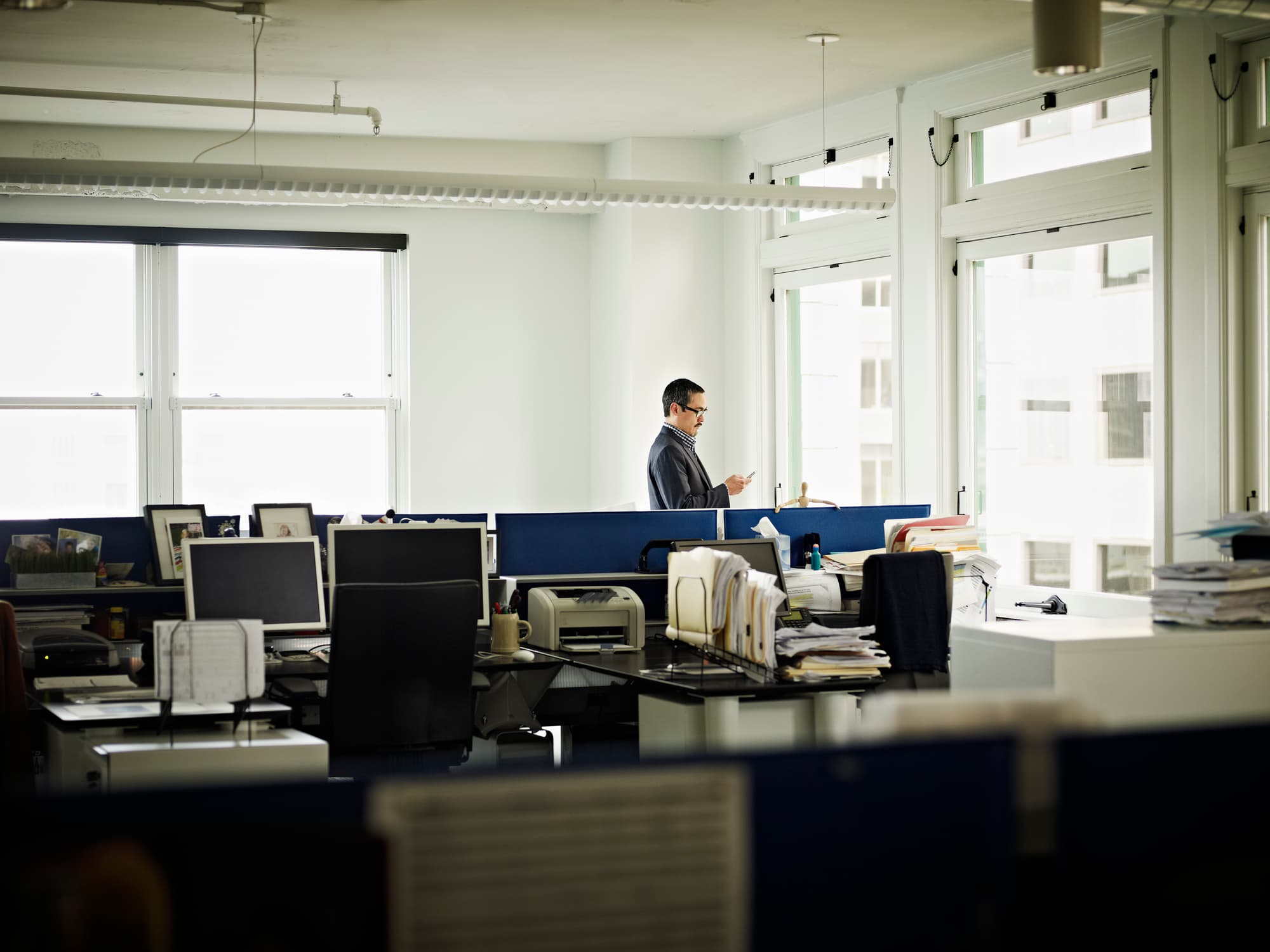 Businessman in office looking at smart phone