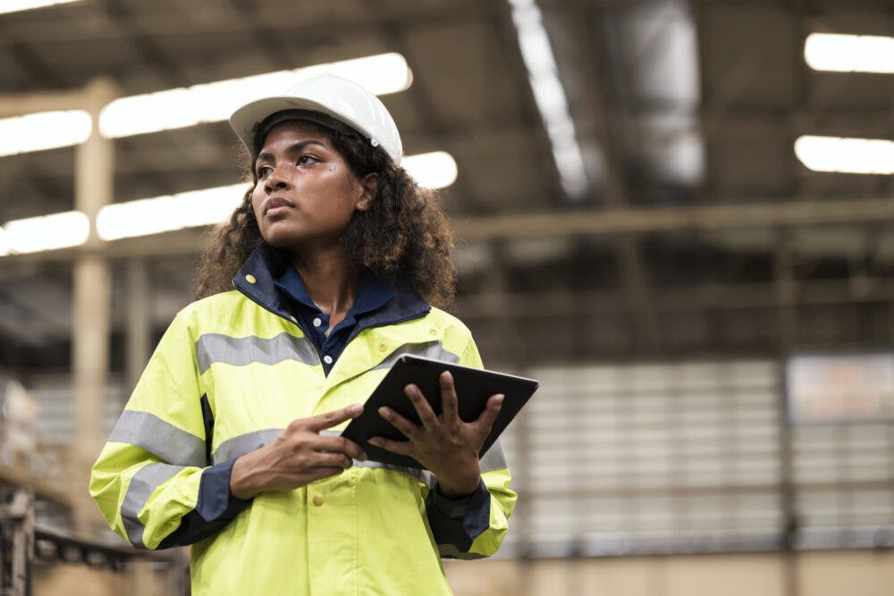 Effectiveness of Gender Equality Empowerment in Manufacturing Industry.  Low Angle View of a Young African American Woman Engineer working in a manufacturing plant and is responsible for controlling, planning for the production process.